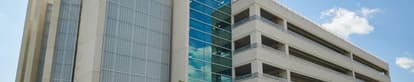 precast parking garage with a commercial building attached.