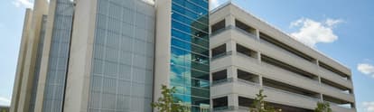 a precast parking garage connected to a commercial building.