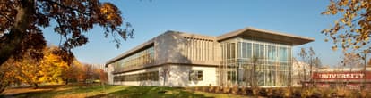 a precast educational building with awnings and large windows.